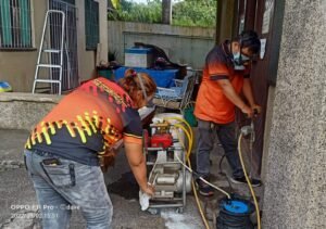 liquid barrier treatments Technicians from Jansen Pest Control Bohol performing termite soil injection treatment around a residential structure.