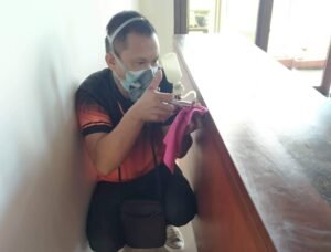 bohol Pest Control Jansen Pest Control Bohol technician applying localized termite treatment on wooden surfaces using precision spray equipment.