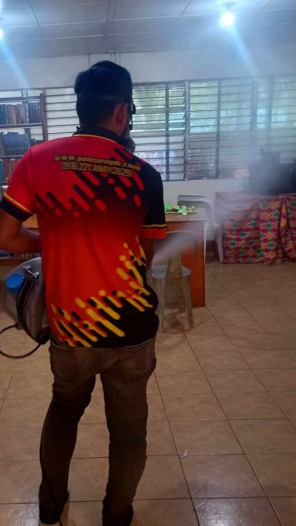 ulv misting in bohol Jansen Pest Control Bohol technician fogging an indoor space with misting equipment, ensuring safe and thorough pest treatment in a community setting.